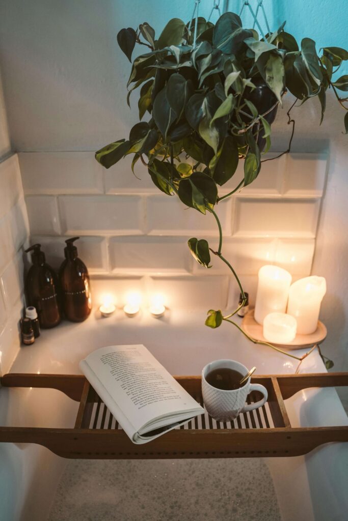 cozy bath set up with candles, tea and a book